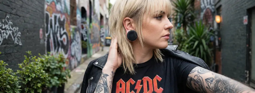 Large stone ear gauges, black obsidian plugs worn by female