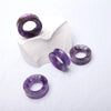 Purple Amethyst Tunnels - Close up photo showing the vibrance of amethyst against the light. Very detailed, interior crystal lines, arrange in a group on a white background. Sizing of tunnels are approx 35mm